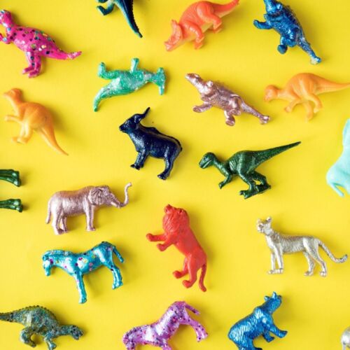 Various animal toy figures colorful background 2